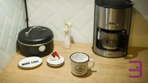 a counter with a coffee maker and a cup of coffee at InVerve Hostel in Timişoara