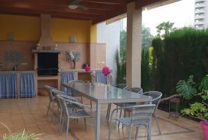 a patio with a table and chairs on a patio at Rey Don Jaime in Benidorm