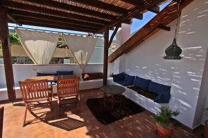 a patio with a table and a chair and a table at Kalkan Turk Evi in Kalkan