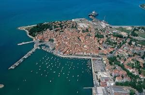 an aerial view of a city with boats in the water at Apartments ROKO in Izola