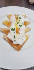 a plate of food with eggs on top of toast at Charter House in Newport