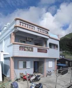 a building with motorcycles parked in front of it at Fu Ya N B&B in Lanyu