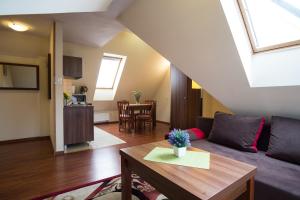 a living room with a couch and a table at Aparthotel Bellamonte in Zakopane