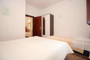 Posteľ alebo postele v izbe v ubytovaní Apartments IVONA 2