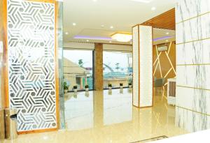 a lobby with a glass door with a geometric pattern at SEASIDE HOTEL in Quy Nhon