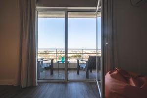 a room with a sliding glass door with a dining table at Star inn Peniche in Peniche +37 photos