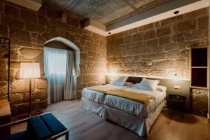 Posteľ alebo postele v izbe v ubytovaní Palacio Condes de Cirac