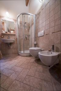 bagno con 2 lavandini, doccia e servizi igienici di Il Chiassetto Bolgheri a Bolgheri