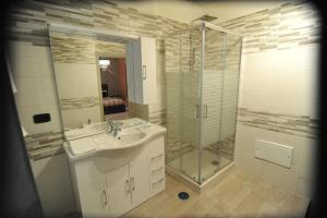 a bathroom with a sink and a glass shower at Tartaglione in Caserta