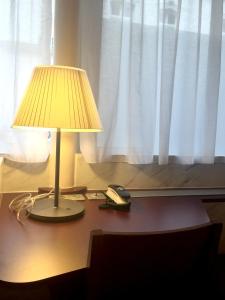 a lamp sitting on a desk next to a window at Hôtel Marignan in Paris