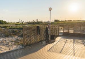 a wooden deck with a fence on the beach at Star inn Peniche in Peniche