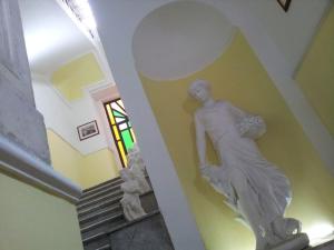 una estatua de una mujer caminando por una escalera en Nuovo Hotel Sangiuliano en Catania