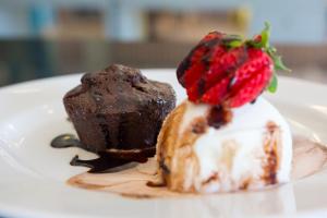 a plate with a chocolate dessert and a strawberry on it at Star inn Peniche in Peniche