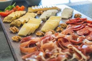 a tray with cheese and other foods on a table at Star inn Peniche in Peniche