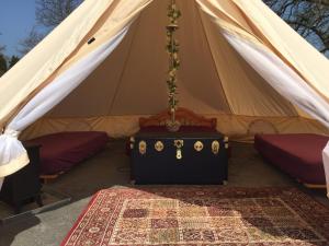a tent with a bed and a canopy at Bell Tent Glamping in Southampton