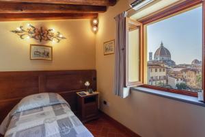 a hotel room with a painting on the wall at Palazzo Graziani in Florence