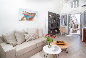 a living room with a couch and a table at Sweet nectar villa at Pyrgos with heated jacuzzi in Pyrgos