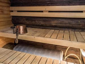 an empty bed in a cabin with a pot on it at Holiday Home Tievatupa 2- pienempi by Interhome in Ylläsjärvi