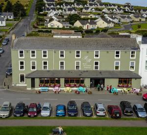 a large building with cars parked in a parking lot at The Beach Hotel in Mullaghmore