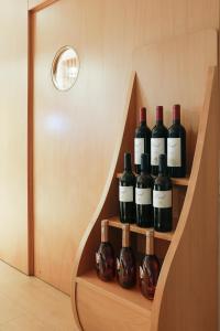 a bunch of wine bottles sitting on a shelf at Stay Hotel Faro Centro in Faro
