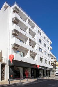 a white building with red hearts on the facade at Stay Hotel Faro Centro in Faro