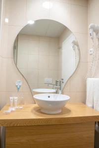 a bathroom with a sink and a mirror at Stay Hotel Faro Centro in Faro