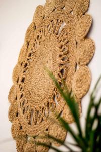 a close up of a crochet flower on a wall at Casa Mawi in Sagres