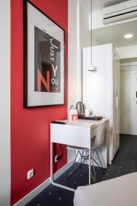 an office with a red wall and a white desk at Stay Hotel Faro Centro in Faro