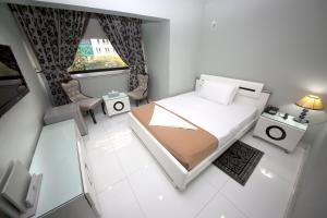 a small room with a bed and a window at White Fort Hotel in Dubai +37 photos