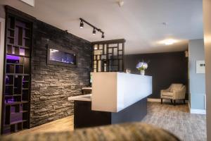 a bar in a room with a stone wall at Newfound Inn & Suites in Topsail