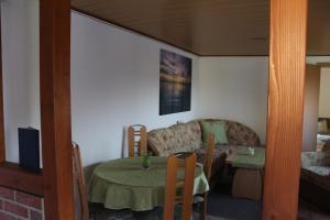 a living room with a couch and a table at Bungalow Groß Dratow in Groß Dratow