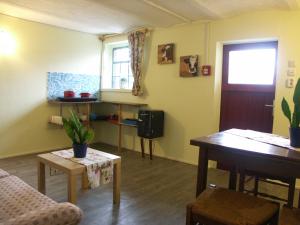 a living room with a couch and a table at Trekkershut Isidorus in Winterberg +4 photos