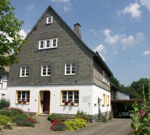uma casa branca com um telhado cinzento em Trekkershut Isidorus em Winterberg