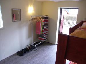 a room with a bedroom with a rack of clothes at Trekkershut Isidorus in Winterberg