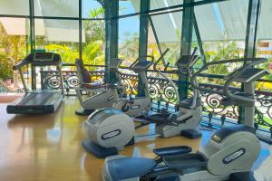 a gym with a bunch of treadmills and ellipticals at Parque Santiago III Official in Playa de las Americas