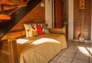a bedroom with a bed with pillows on it at El Paso departamentos in San Juan