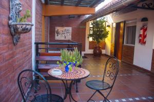 a small table and chairs on a patio at El Paso departamentos in San Juan