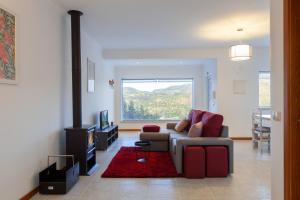 a living room with a couch and a fireplace at Casas Ponte D'Alge in Foz de Alge