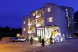 a purple building with a car parked in front of it at Boutique Hotel Bol in Bol