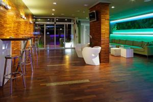 a bar with stools and a couch in a room at Boutique Hotel Bol in Bol