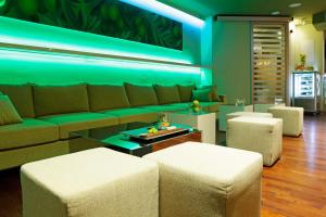a living room with a couch and stools at Boutique Hotel Bol in Bol