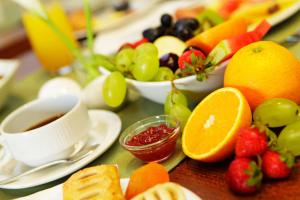 a table filled with fruit and a cup of coffee at Boutique Hotel Bol in Bol