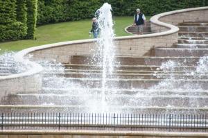 a fountain in a park with people walking around it at Percy Terrace Bed and Breakfast in Alnwick