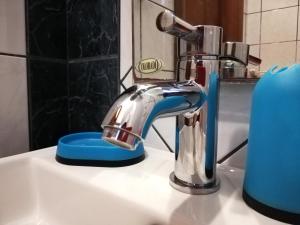a bathroom sink with a faucet on a sink at Aspa's Apartment in Kavála +60 photos
