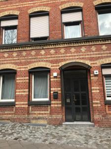 a brick building with a black door at Harry's Apartment in Erfurt