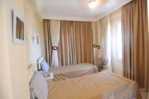 una camera d'albergo con due letti e una finestra di Gold City Private Pool Villa 3+1 with Free AquaPark a Alanya Altre 48 foto