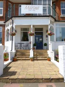 a front porch of a building with a sign that reads marina at Beamsley Lodge B&B in Eastbourne