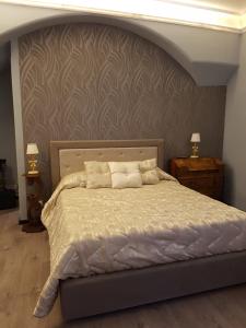 a bedroom with a large bed with a wall at Hotel Sangiuliano 132 centro storico Catania in Catania
