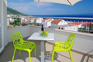a table and two chairs on a balcony with a view at Boutique Hotel Bol in Bol