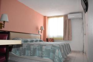 Postel nebo postele na pokoji v ubytování Hotel Baluarte
